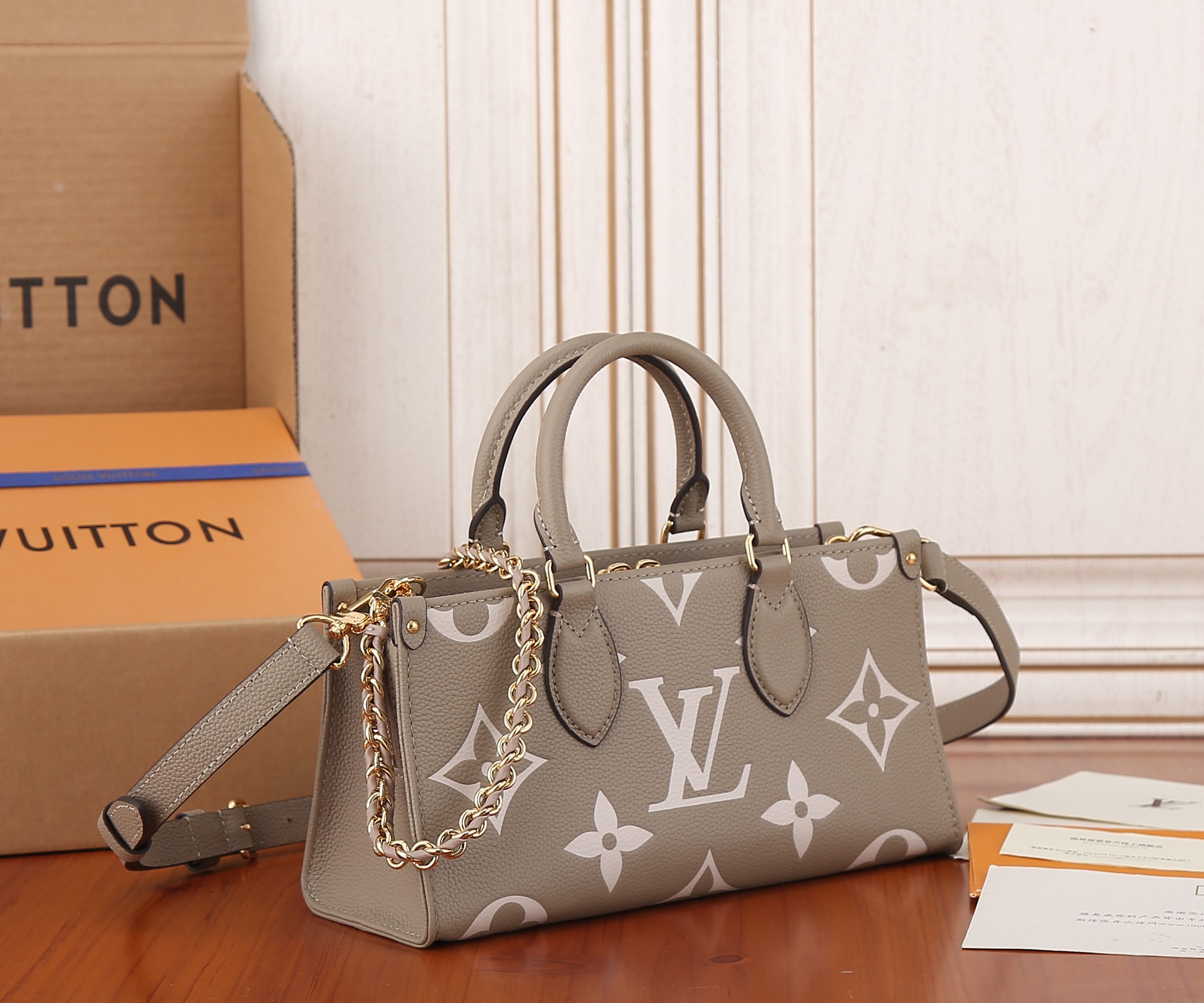 Onthego East West Chain Bicolor Monogram Empreinte Leather Dove/Cream M23641