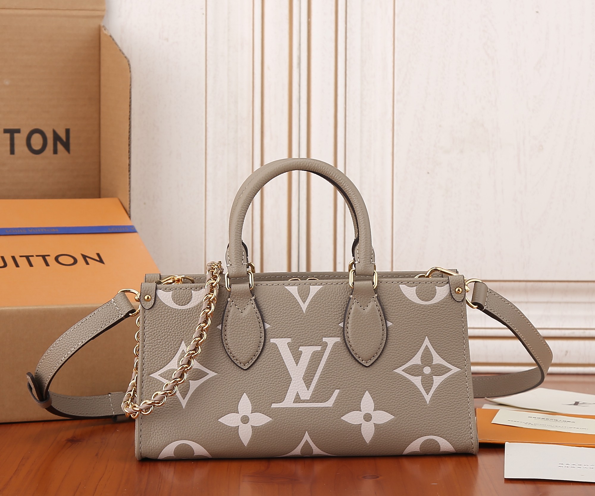 Onthego East West Chain Bicolor Monogram Empreinte Leather Dove/Cream M23641