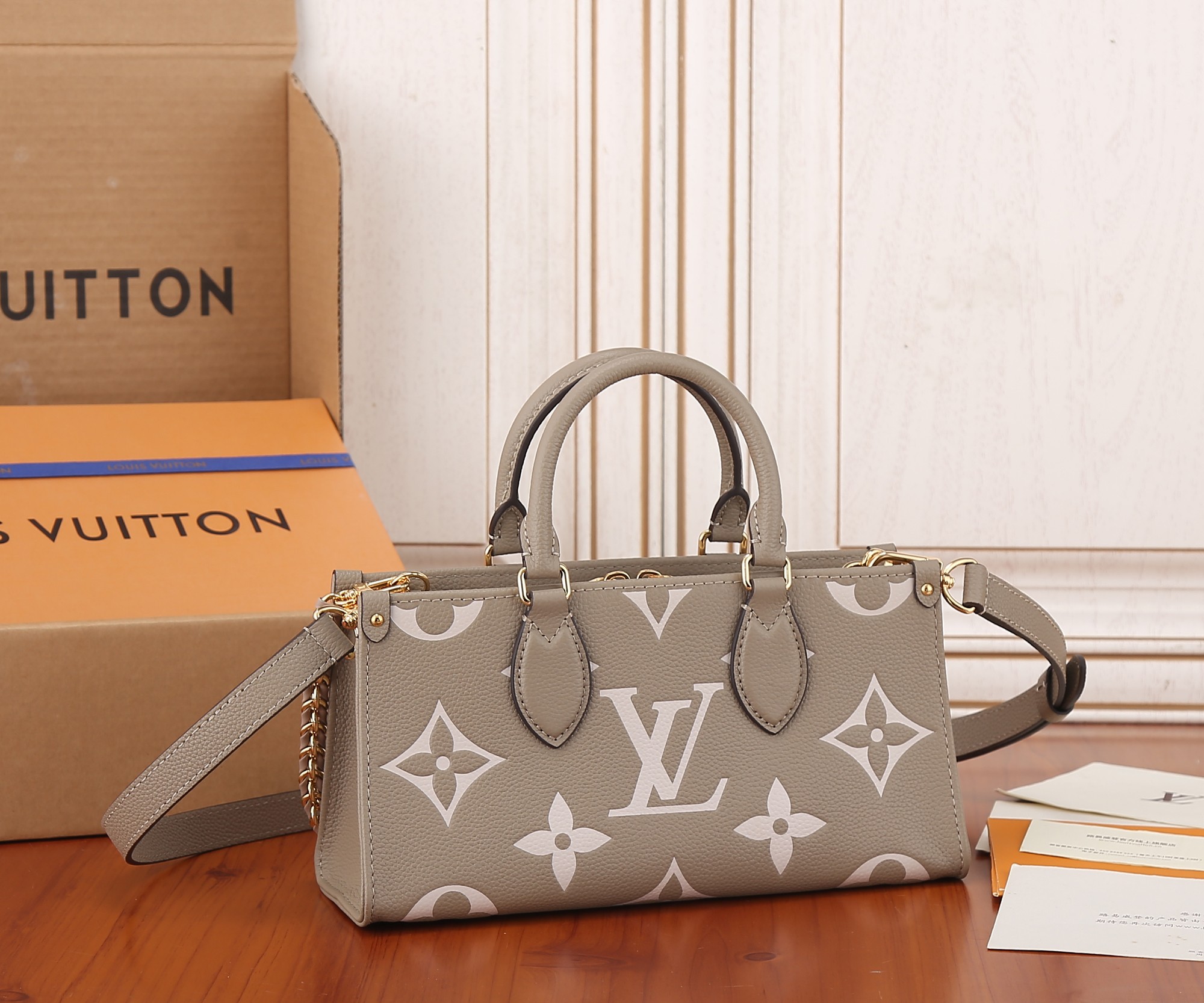 Onthego East West Chain Bicolor Monogram Empreinte Leather Dove/Cream M23641