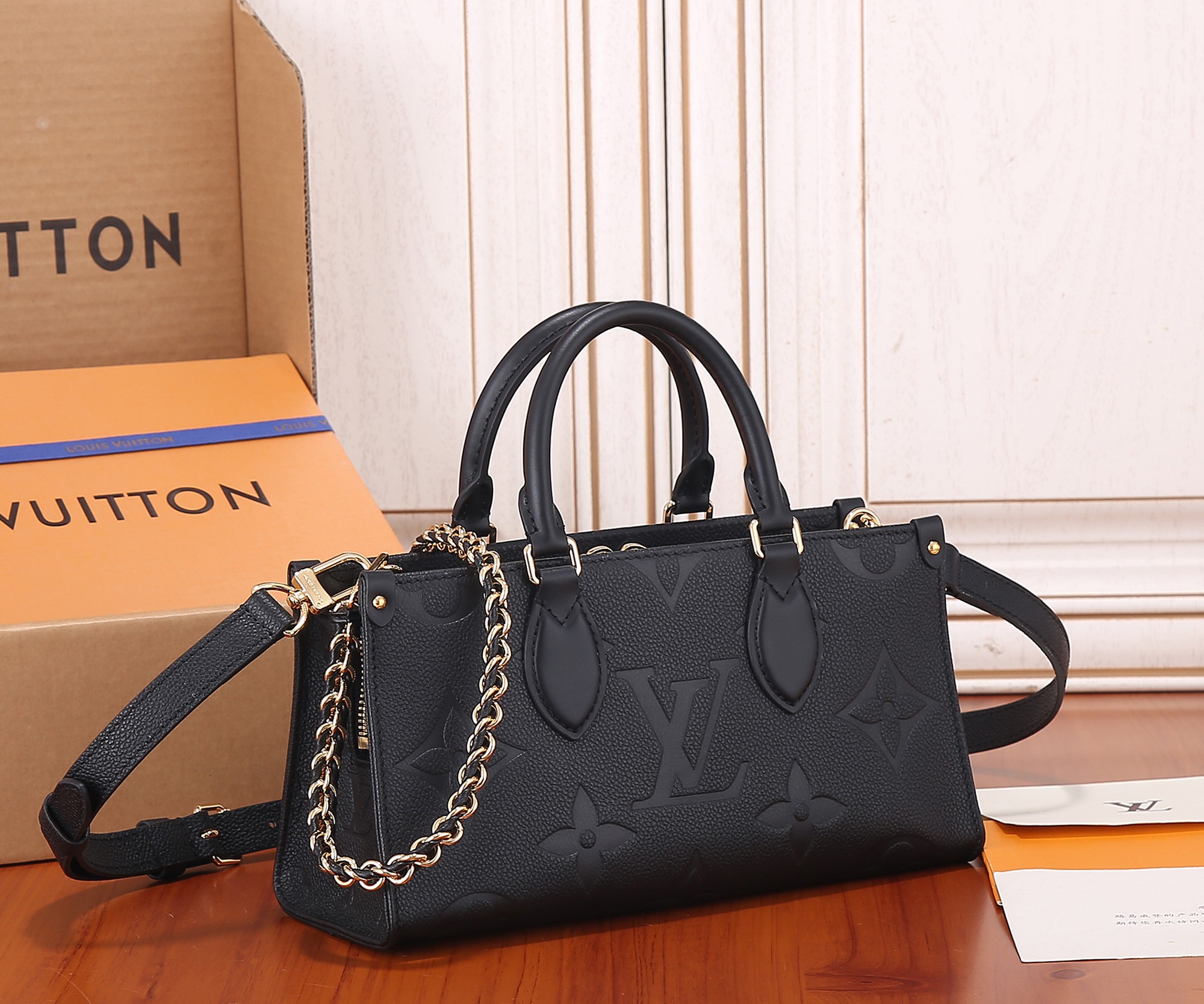 Onthego East West Chain Monogram Empreinte Leather Black M23640