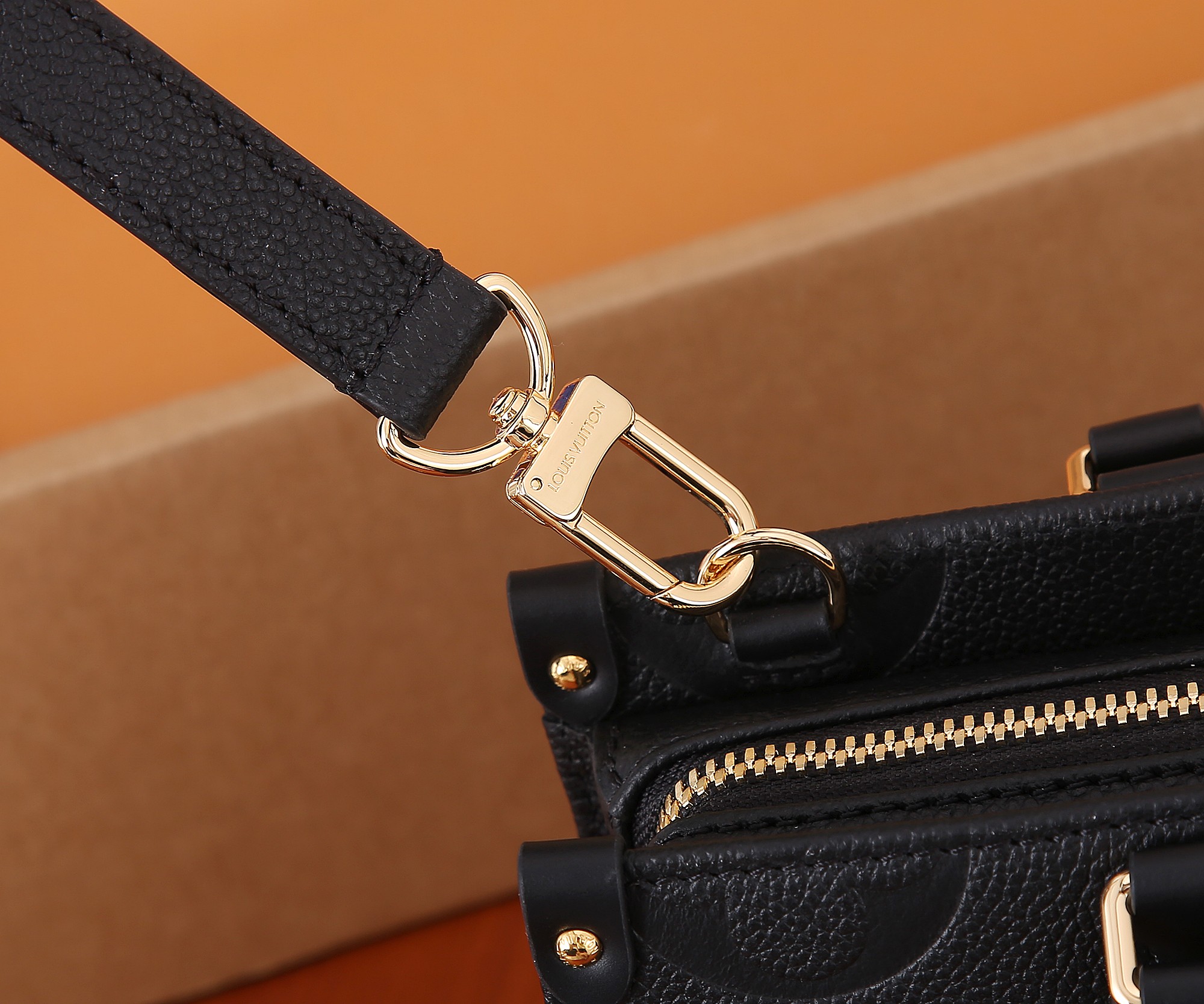 Onthego East West Chain Monogram Empreinte Leather Black M23640