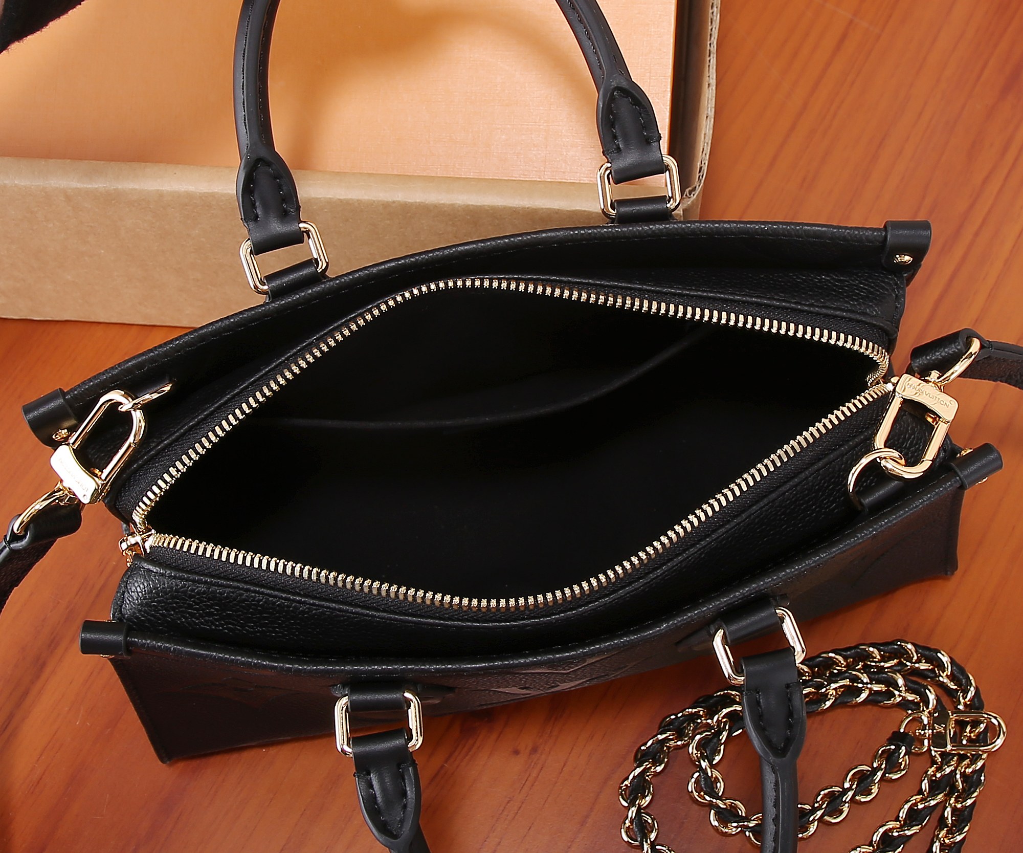 Onthego East West Chain Monogram Empreinte Leather Black M23640