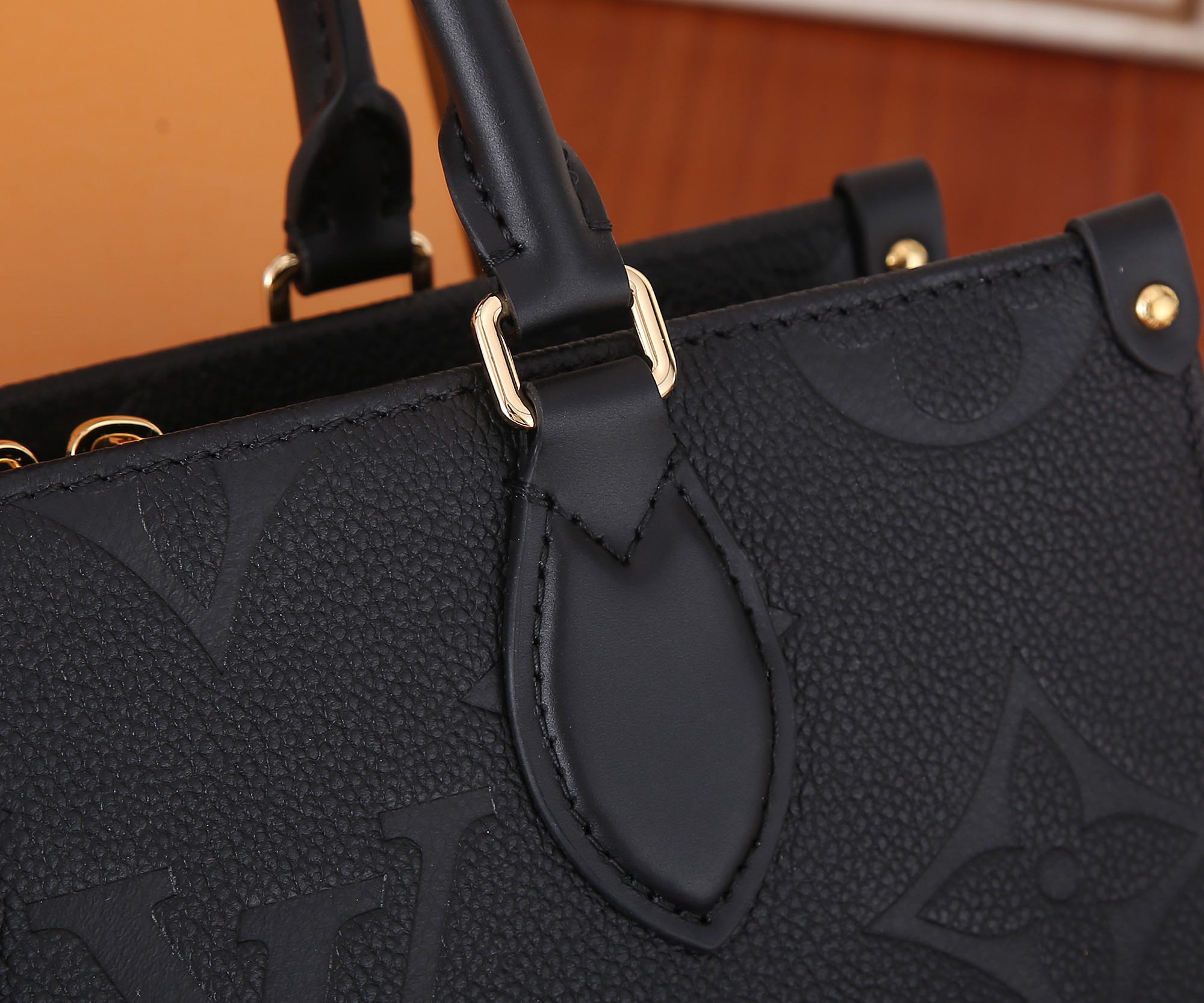 Onthego East West Chain Monogram Empreinte Leather Black M23640