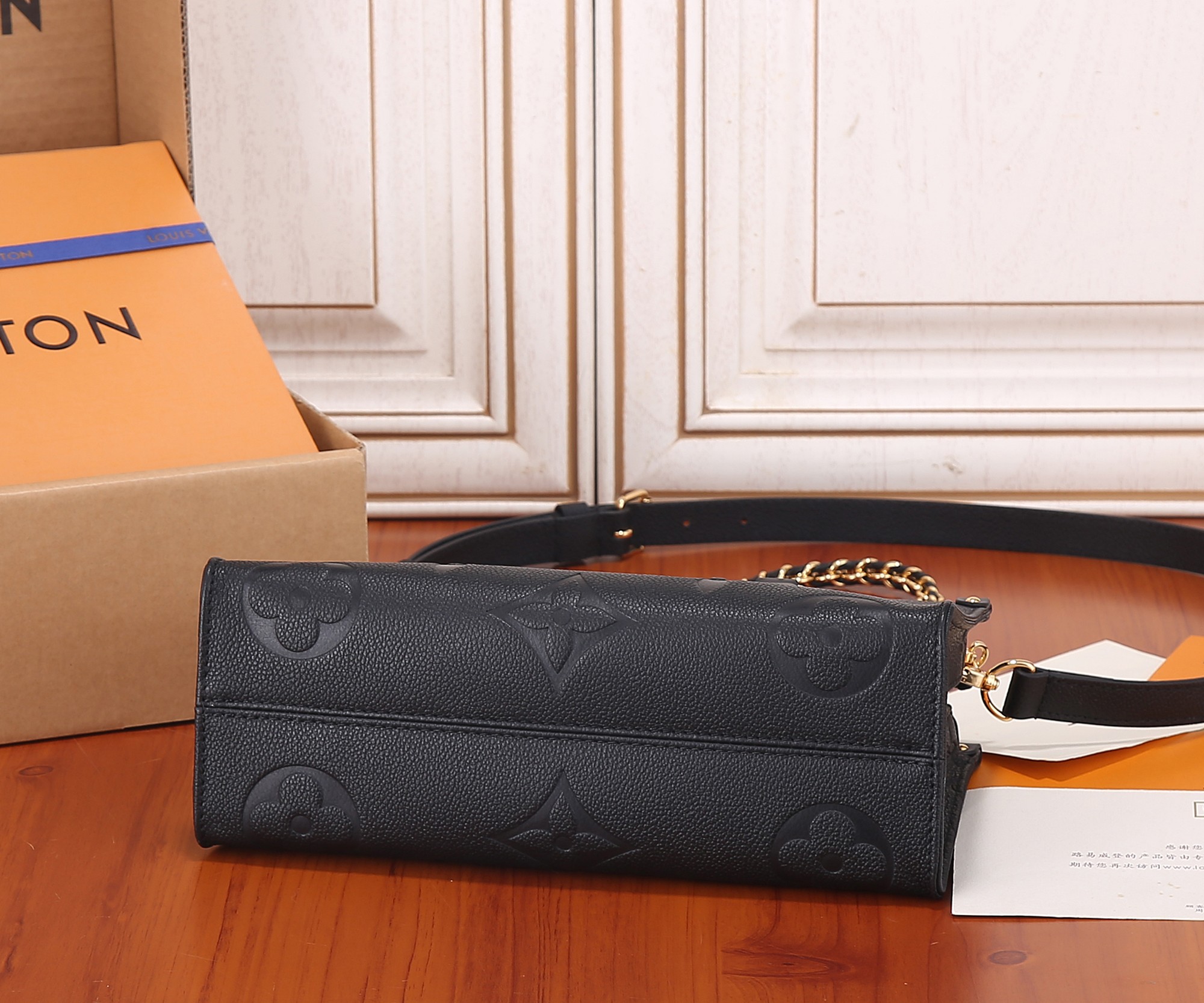 Onthego East West Chain Monogram Empreinte Leather Black M23640