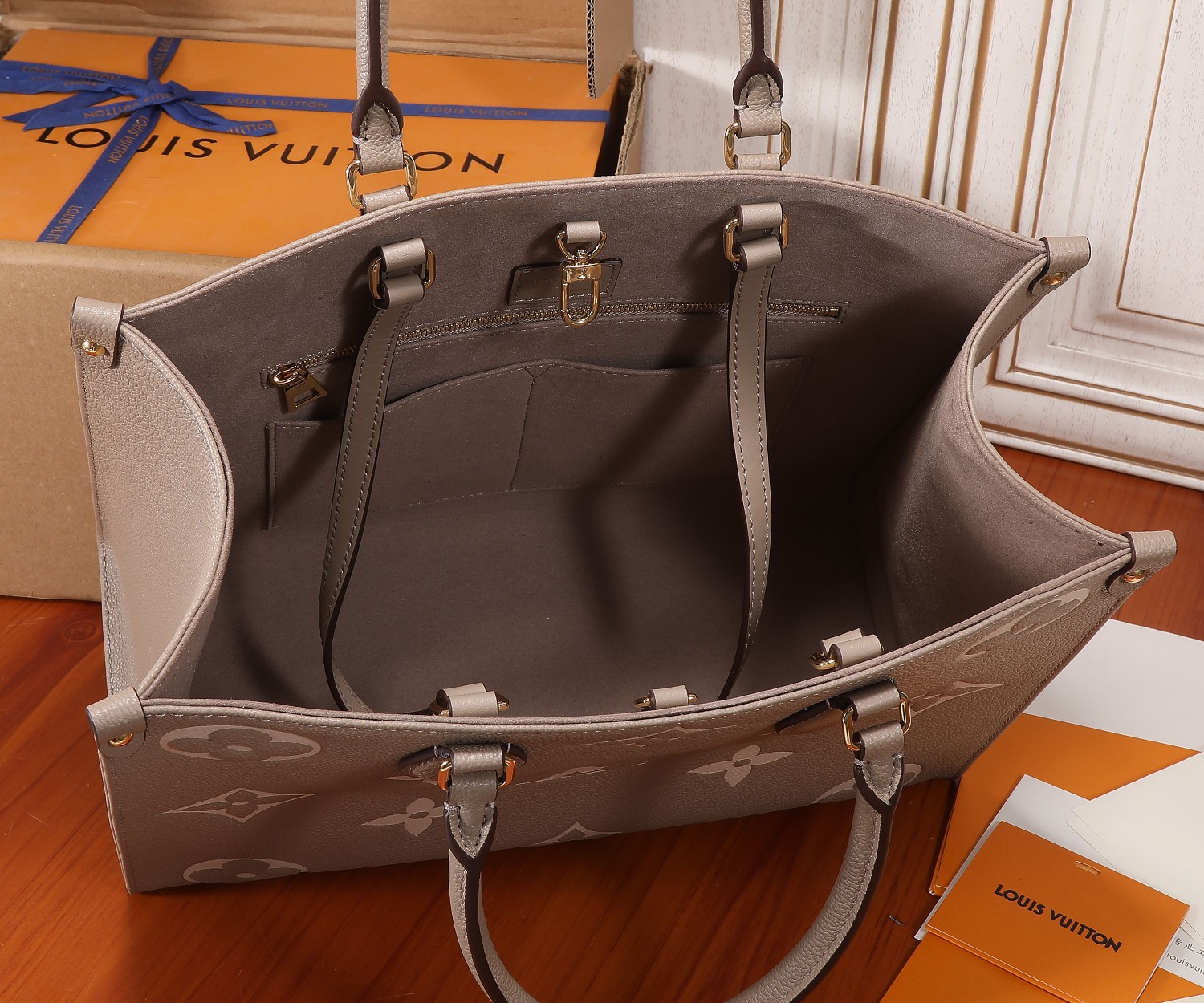 Onthego Mm Bicolor Monogram Empreinte Leather Dove/Cream M45494