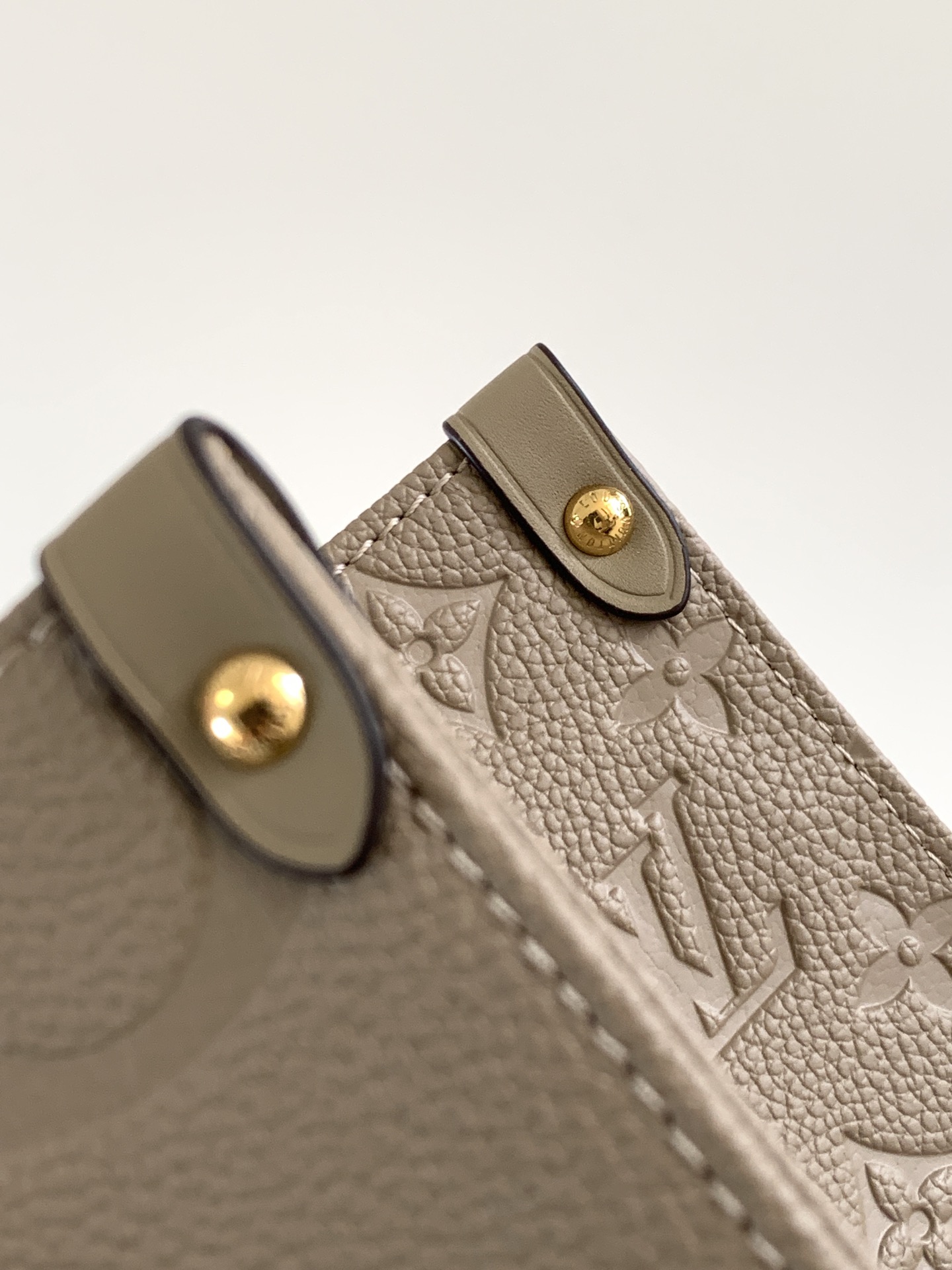 Onthego Mm Monogram Empreinte Leather Tourterelle Beige M45607