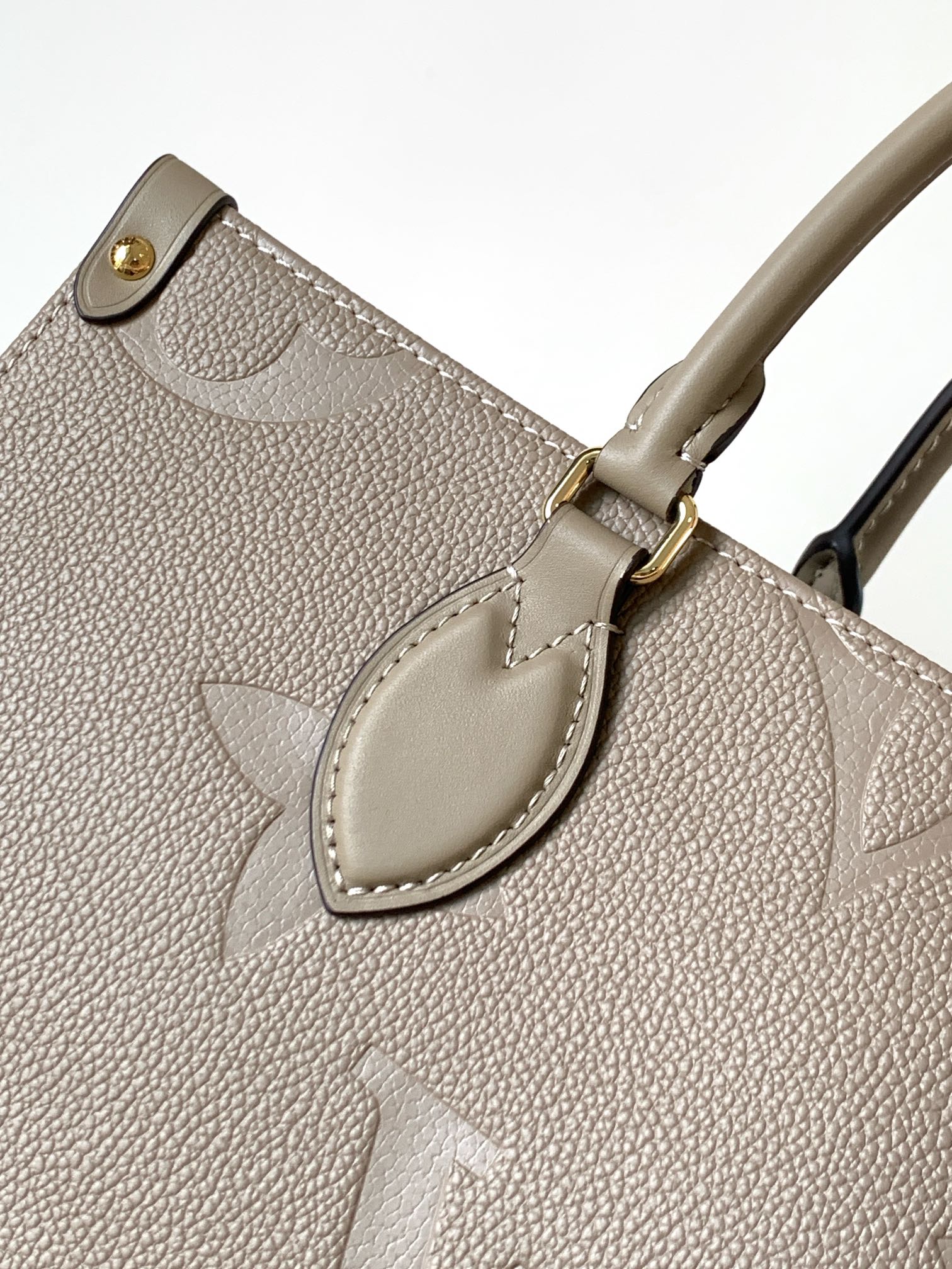 Onthego Mm Monogram Empreinte Leather Tourterelle Beige M45607